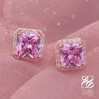 Pink gemstone earrings with rose gold setting on a pink background, Zuffun brand visible.